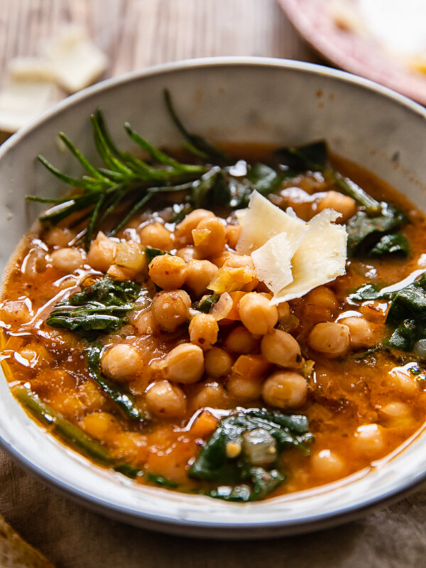 Bowl of Tuscan chickpea soup with rosemary and hard cheese