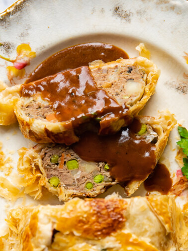 slices of ground beef wellington with gravy