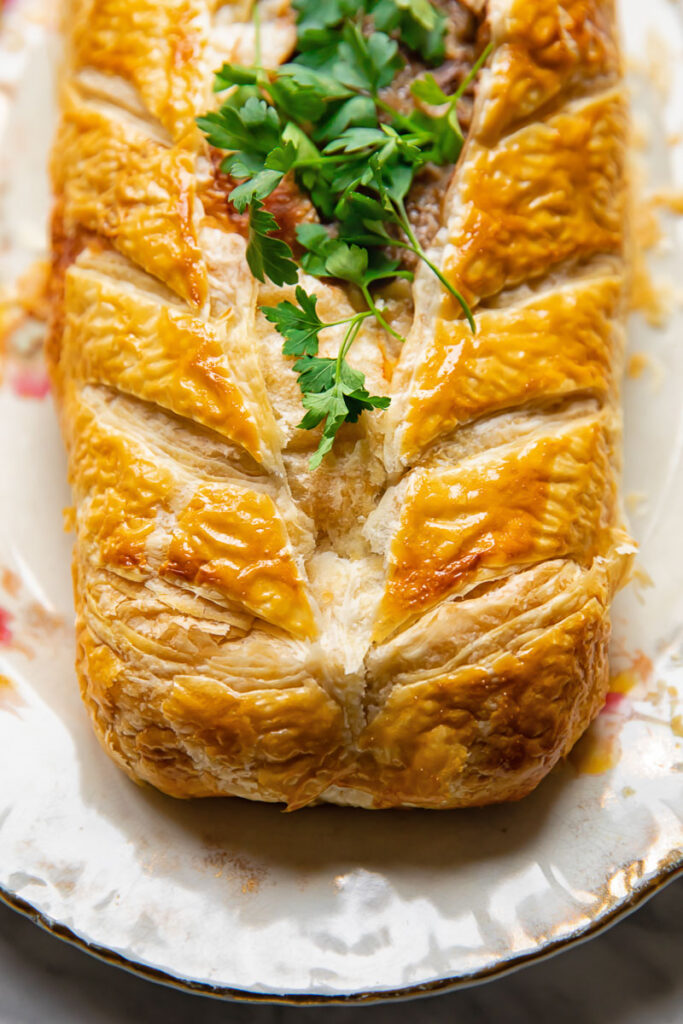 close up of the pastry stuffed with meat with parsley on top