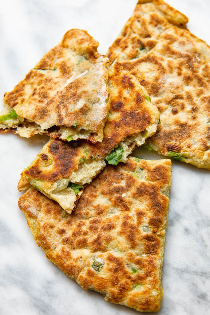 Close up shot of cut open pieces of irish potato farls stack on top each other