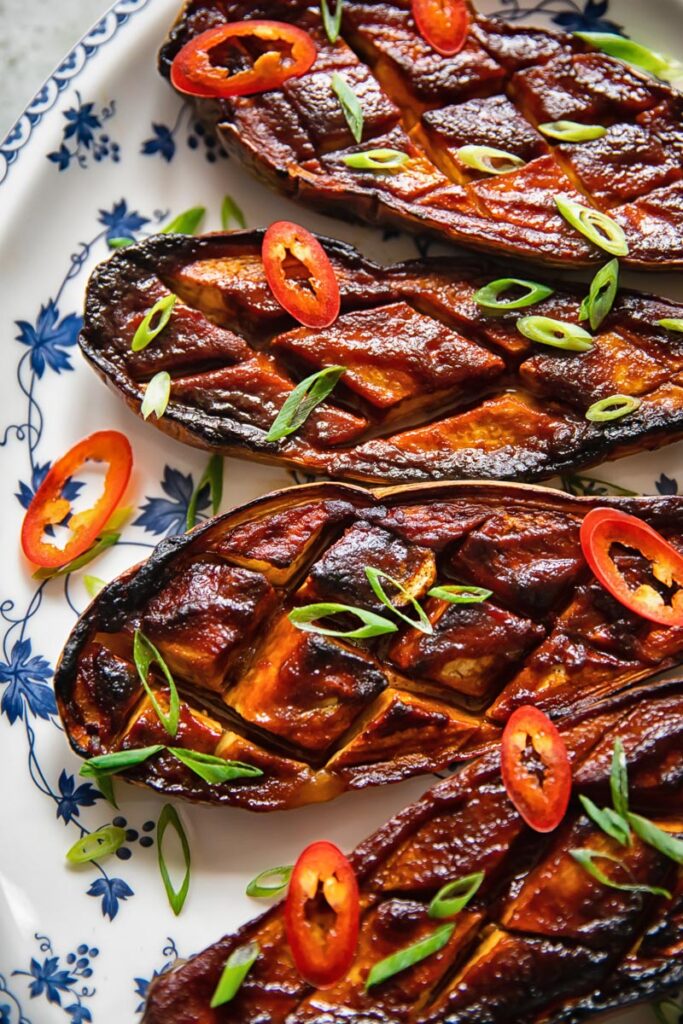 four glazed eggplant on a plate from close up