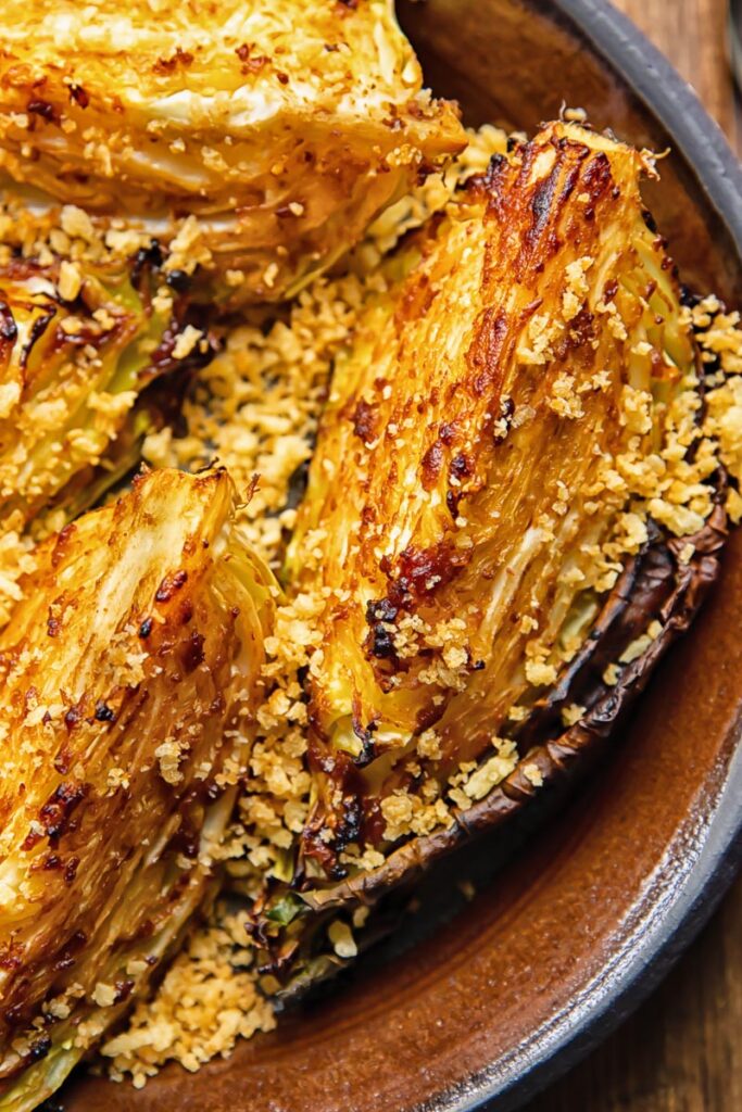 close up of miso butter roasted cabbage wedges on a plate