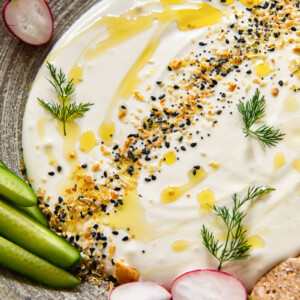 Close up of whipped feta dip with vegetables on a plate