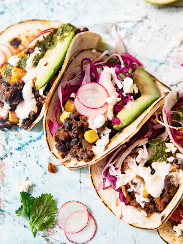 Black bean tacos half folded with cilantro lime slaw