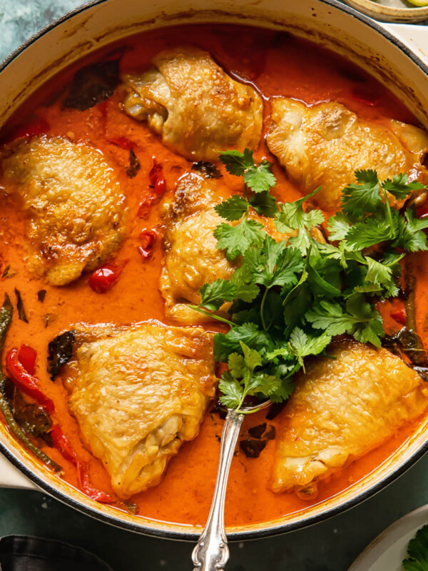 top down view of the braised coconut curry with chicken thighs and a bunch of parsley