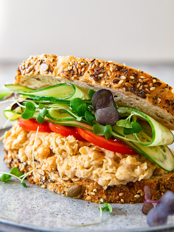 Angled view of chickpea salad sandwich on a plate