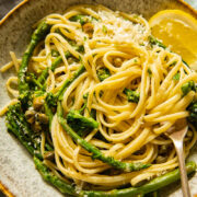 Bowl with the pasta and a slice of lemon with a fork