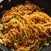 wok full of spicy peanut noodles