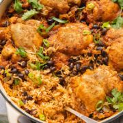 Top down shot of mexican chicken rice in a pan topped with black beans and cilantro