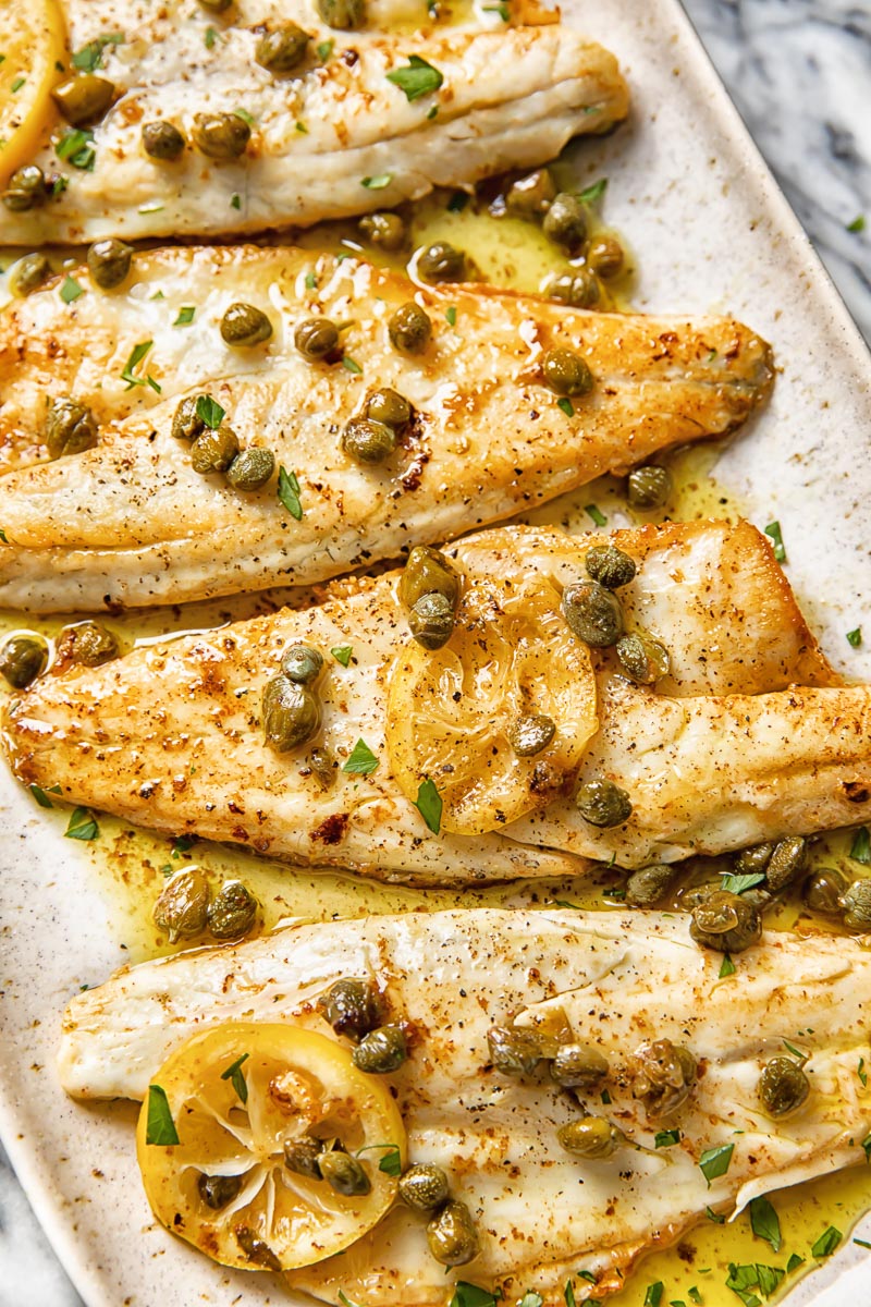 close up of sea bass fillets in brown butter caper sauce