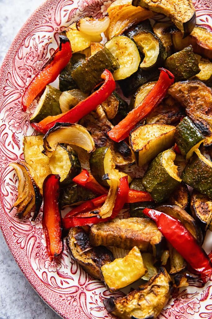 Roasted vegetables on a pink serving plate