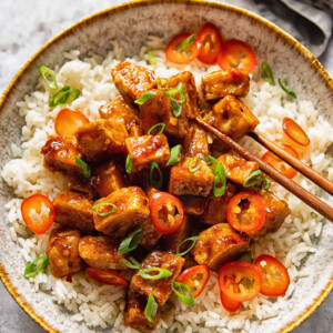bowl of hoisin glazed tofu and chopsticks