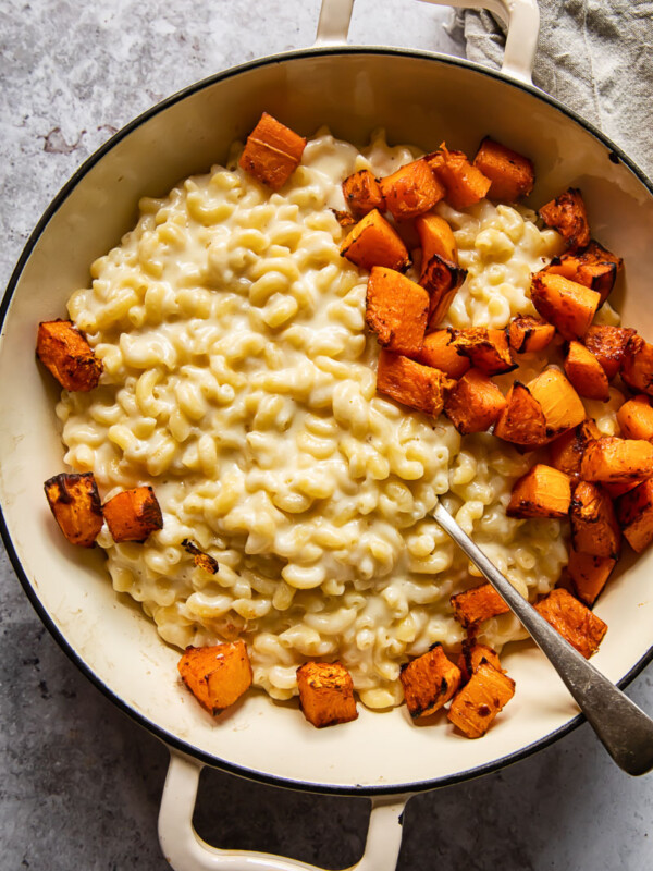 Pan of butternut squash macaroni and cheese with a spoon