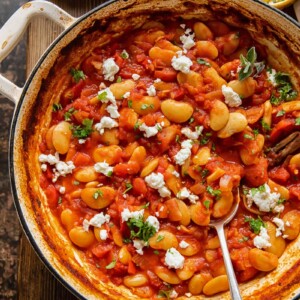 Pan of butter bean stew in a pot with spoon