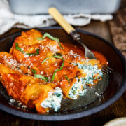 Plate of spinach and ricotta cannelloni on a wooden table
