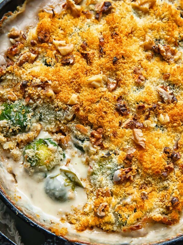 Close up shot of cheesy Brussels sprouts gratin in a deep pan topped with breadcrumbs