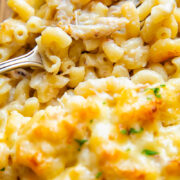 Close up shot of a bite of crab mac and cheese from a baking dish