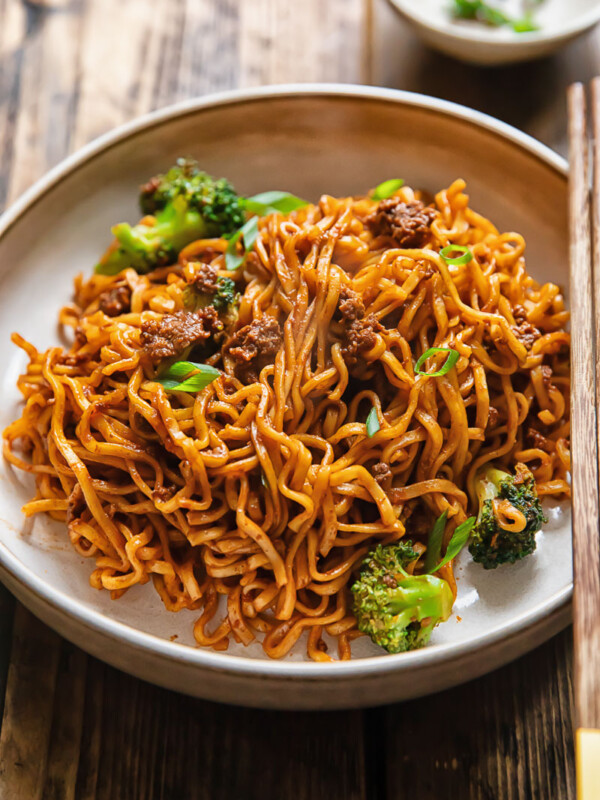 Side shot of gochujang noodles in a wide bowl on a table