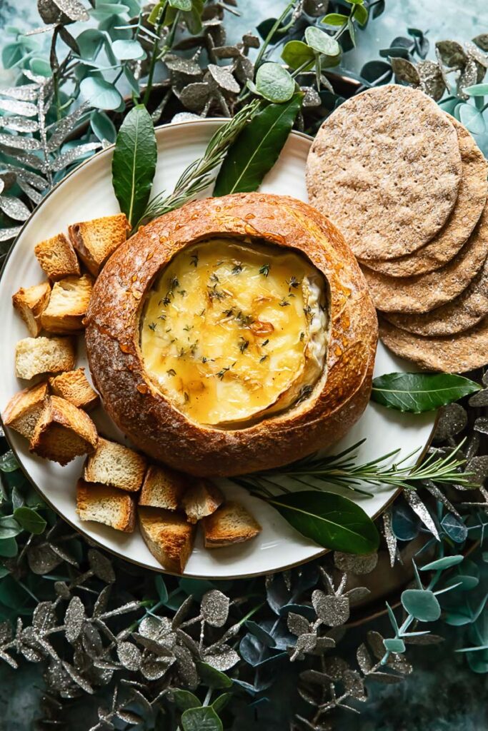 Top down shot of baked camembert in a bread bowl