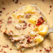 Close up shot of bacon cheeseburger soup being ladled out of a pot