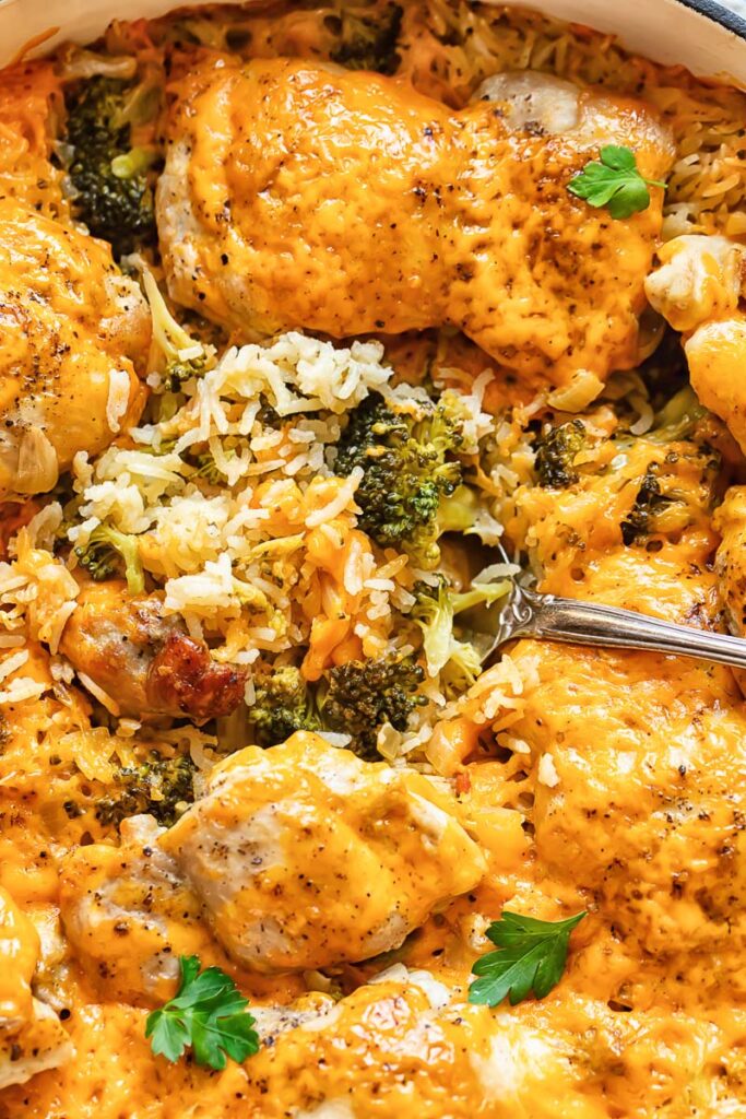Close up[ shot of chicken broccoli rice casserole being scooped out of a pan