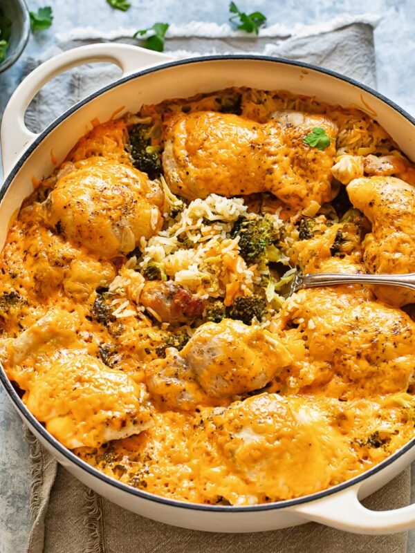Top down shot of cheesy chicken and broccoli casserole in a large pan with rice