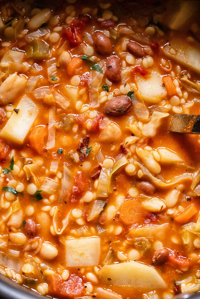 Close up shot of Sardinian minestrone with cannelloni beans, potato and small pasta