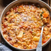 Top down shot of Sardinian minestrone in a pot with a spoon