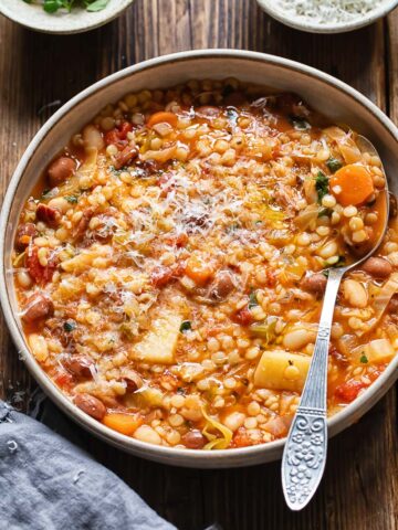 Top down shot of Sardinian minestrone in a pot with a spoon