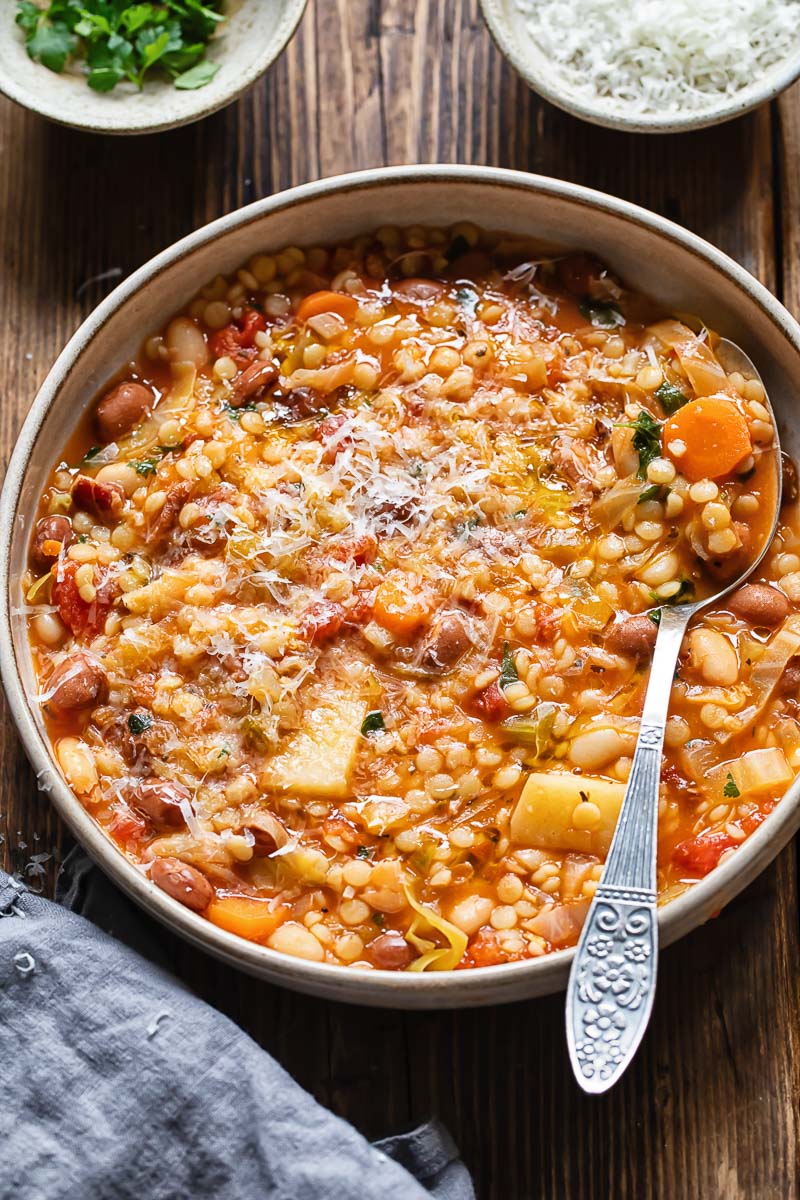 Top down shot of Sardinian minestrone in a pot with a spoon