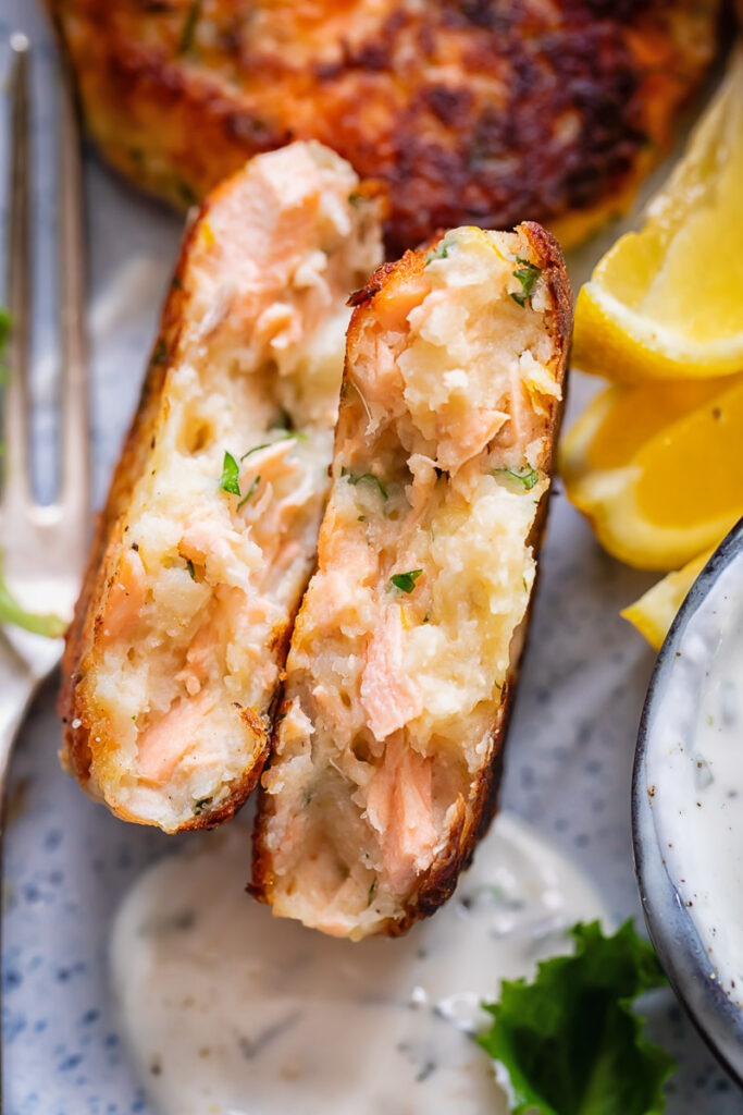 Close up shot of salmon cakes cross section with fluffy potato inside