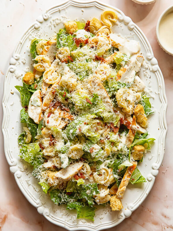 Top down view of chicken Caesar pasta salad on a serving platter
