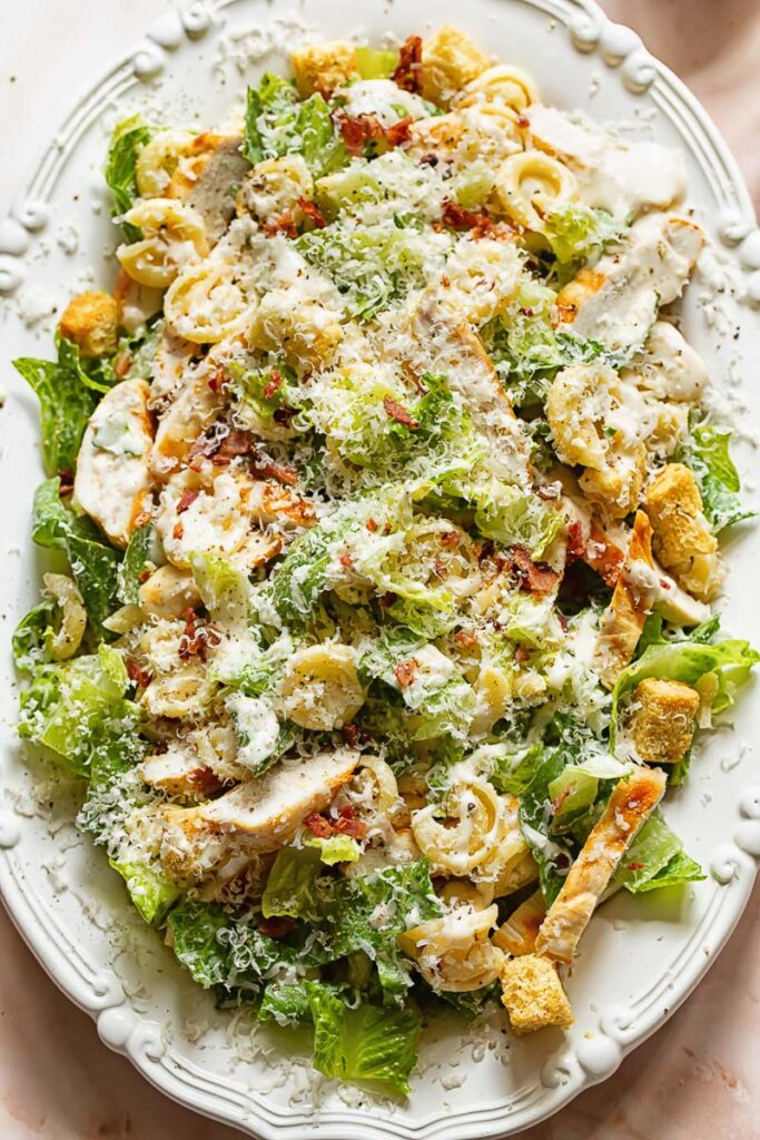 Top down view of chicken Caesar pasta salad on a serving platter