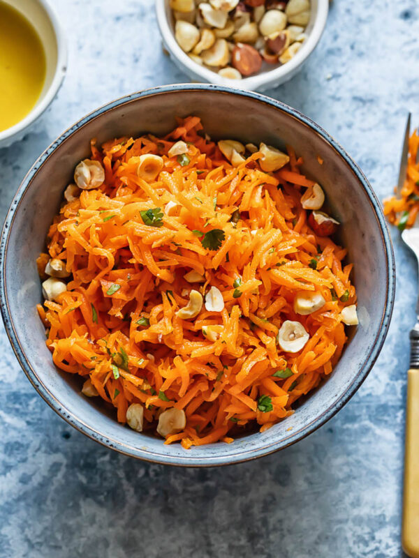Top down shot of french carrot salad in a small bowl
