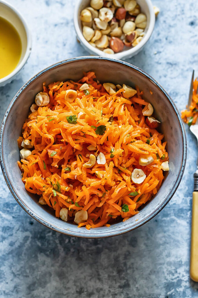 Top down shot of french carrot salad in a small bowl