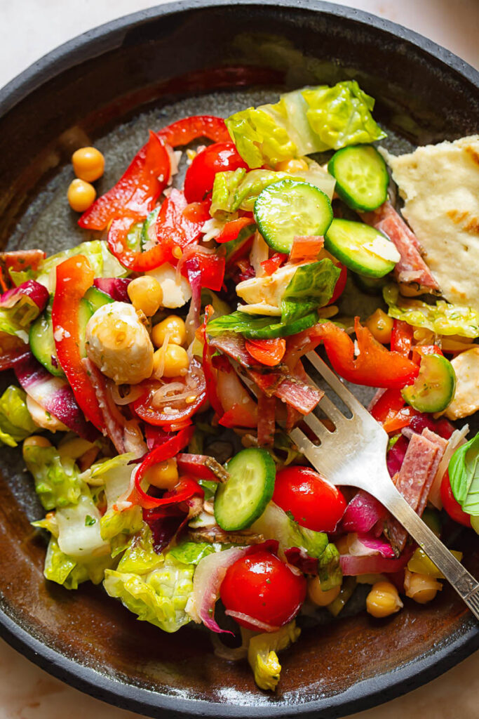 Close up shot of Italian chopped salad on a plate with bread
