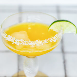 Passion fruit margarita in a glass with a salt rim