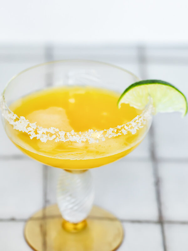 Passion fruit margarita in a glass with a salt rim