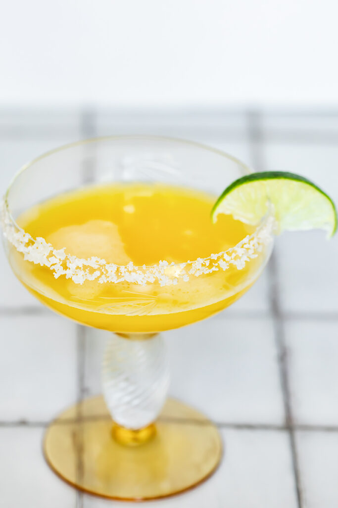 Passion fruit margarita in a glass with a salt rim