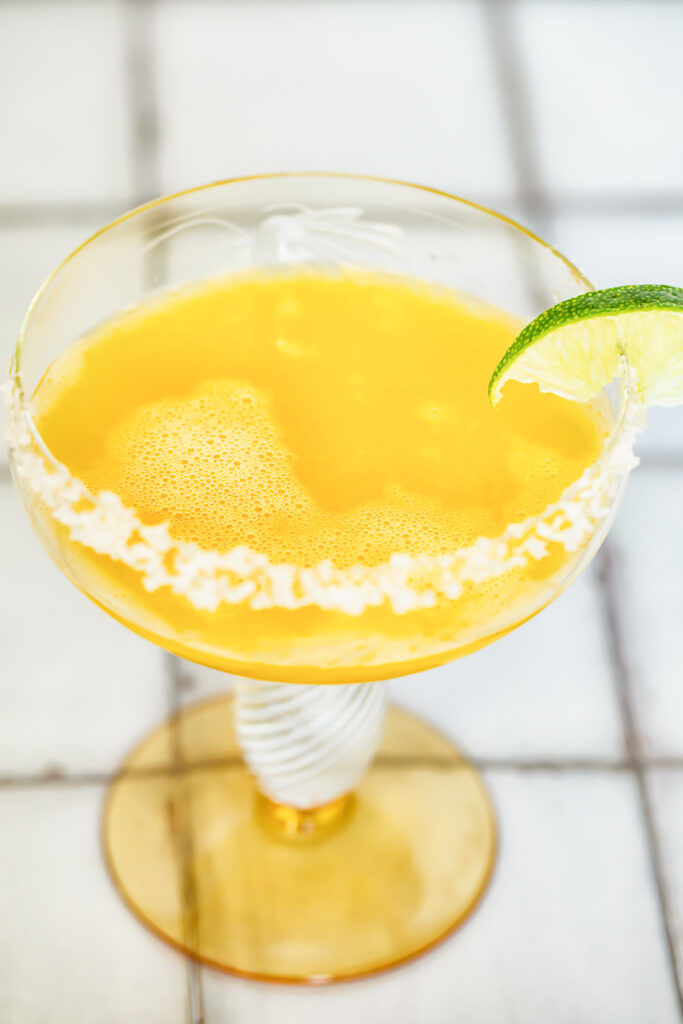 Passion fruity margarita with a lime slice on the rim