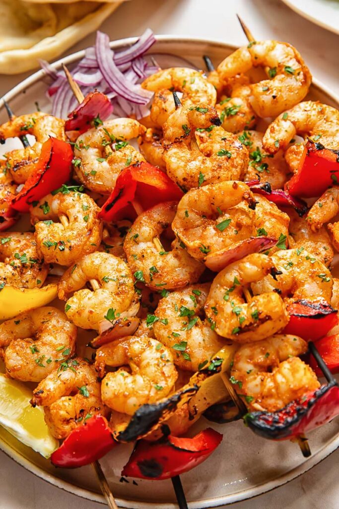 Top down shot of shrimp kebabs on a platter