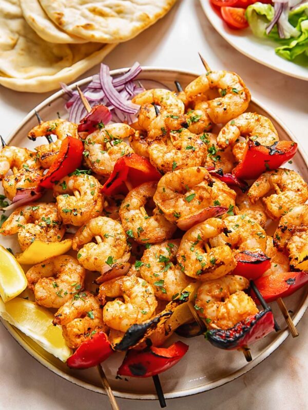 Shrimp kebabs skewers stacked on top of each other on a plate