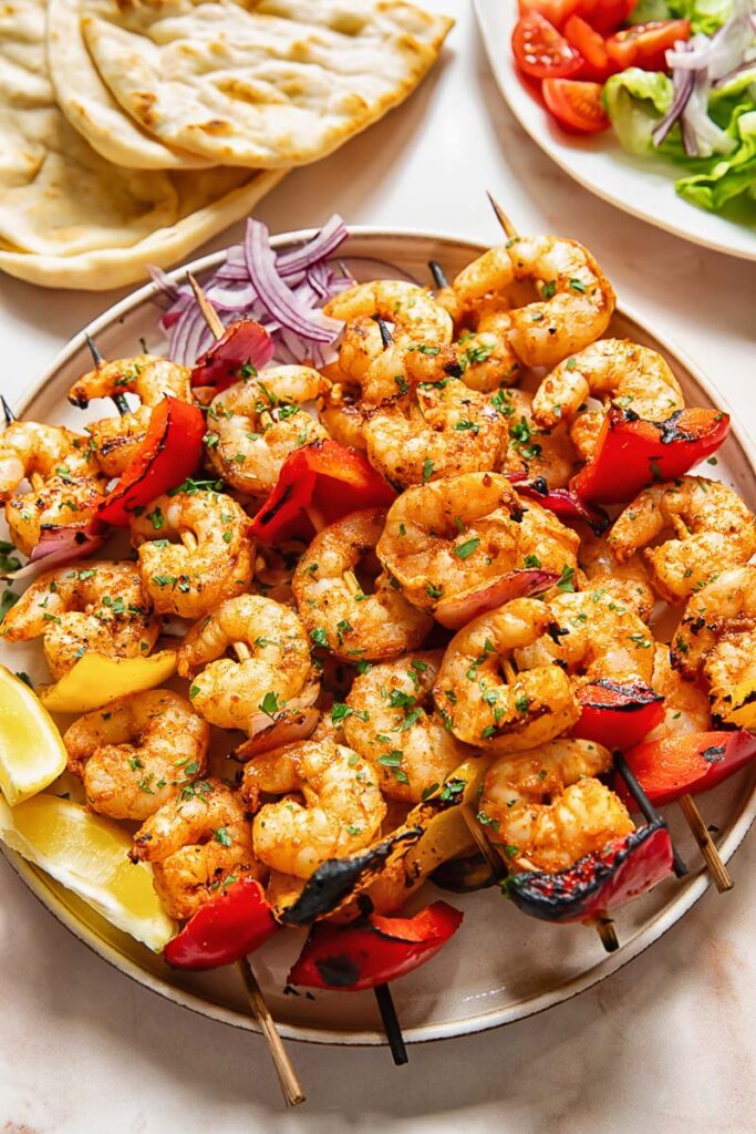 Shrimp kebabs skewers stacked on top of each other on a plate