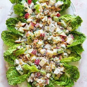 Top down shot of chicken waldorf salad on a bed of lettuce