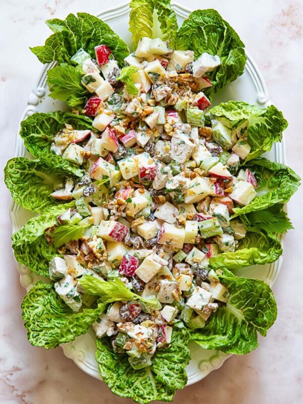 Top down shot of chicken waldorf salad on a bed of lettuce