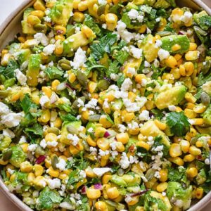 Top down shot of avocado and corn salad in a wide bowl
