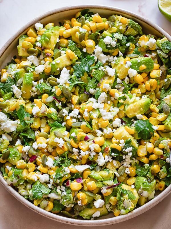 Top down shot of avocado and corn salad in a wide bowl