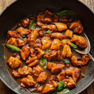 Top down shot of three cup chicken in a pan