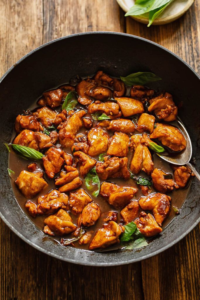 Top down shot of three cup chicken in a pan