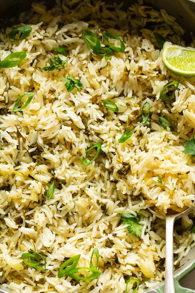 Close up of cilantro lime rice with a serving spoon